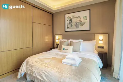 a bedroom with a bed with towels on it at HiGuests - Sky-High Experience Luxe Living on the 24th Floor in Dubai