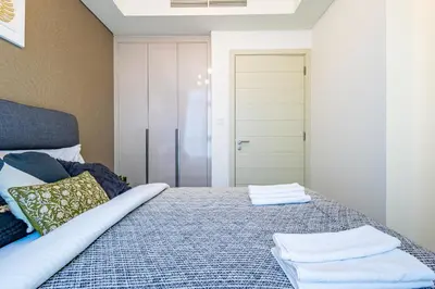 a bedroom with a bed with two towels on it at Luxury 3BR 2storey Villa with Garden in Damac Hills in Dubai