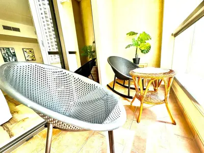 a chair and a table on a balcony at Stylish beachside apartment 3 beds in JBR in Dubai