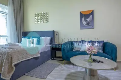 a living room with a couch and a table at Bloomfields Deluxe Stu Jlt Near Metro in Dubai