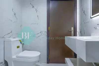 a bathroom with a toilet and a sink at Bloomfields Deluxe Stu Jlt Near Metro in Dubai