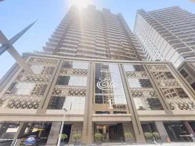 a tall building with a sign on it at Close to Downtown - New 1 bedroom with parking in Dubai