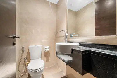 a bathroom with a white toilet and a sink at Big 1 bedroom close to Downtown in Dubai