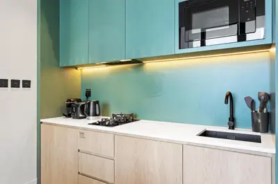 a kitchen with a sink and a microwave at Stylish Studio in Upside Living with Top Amenities in Dubai