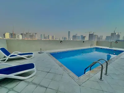 a swimming pool on the roof of a building at Charming Studio Retreat in Central JVC by Bhavan Vacation Homes in Dubai