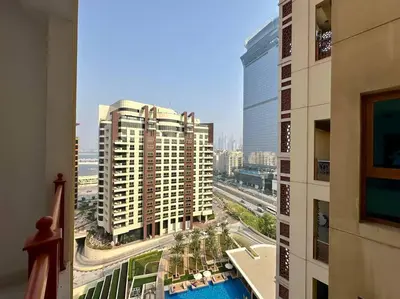 a view of a city from a balcony of a building at Manzil - 2BR Home with Waterfront Views in Palm in Dubai