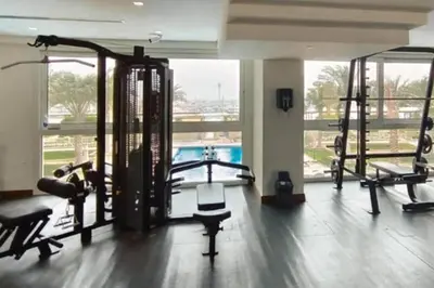a gym with treadmills and machines in a building at Manzil - 2BR Home with Waterfront Views in Palm in Dubai