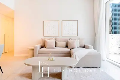 a living room with a couch and a table at LUX The JBR Garden View Suite in Dubai