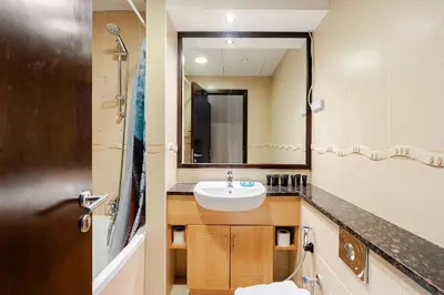 a bathroom with a sink and a mirror at Amazing lake skyline view cozy apartment in Dubai