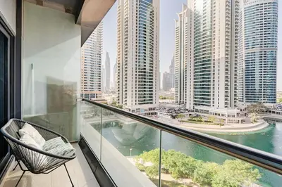 a balcony with a view of a city at Amazing lake skyline view cozy apartment in Dubai