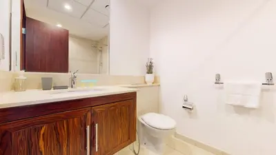 a bathroom with a toilet and a sink and a tub at The Residences II - One Bed with Burj Khalifa View in Dubai