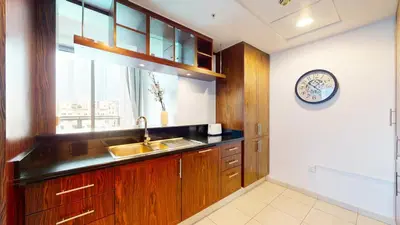 a kitchen with a sink and a clock on the wall at The Residences II - One Bed with Burj Khalifa View in Dubai