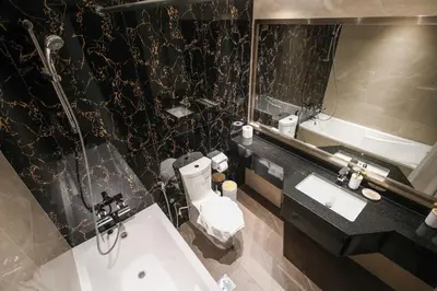 a bathroom with a sink and a toilet and a mirror at Spacious 1BR - Elite Downtown Residence - Short Walk to Burj & Dubai Mall in Dubai
