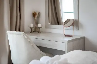 a mirror and a chair in a room at Seven Palms in Dubai
