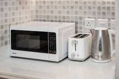 a white microwave sitting on top of a kitchen counter at Seven Palms in Dubai