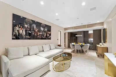 a living room with a white couch and a table at Five Palm Luxury - 2BR with Pool View, Gym & Prime Beach Stay in Dubai