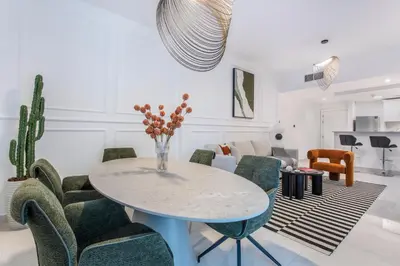 a living room with a table and chairs at Comfy 1BR Marina Living Steps from Marina Walk in Dubai