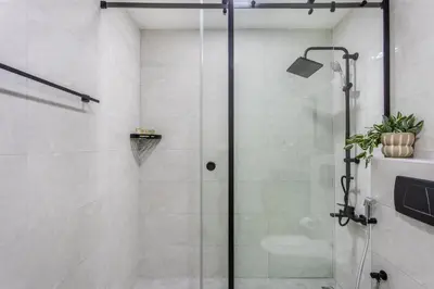 a shower with a glass door in a bathroom at Comfy 1BR Marina Living Steps from Marina Walk in Dubai