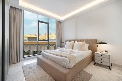 a bedroom with a large bed and a large window at Upscale 2BR with Private Terrace & Pool View in Dubai