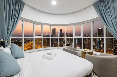 a bedroom with a white bed and a large window at Stunning Panoramic Sea & Marina City Skyline View in Dubai