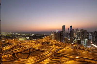a busy freeway in a city at night at Stunning Panoramic Sea & Marina City Skyline View in Dubai