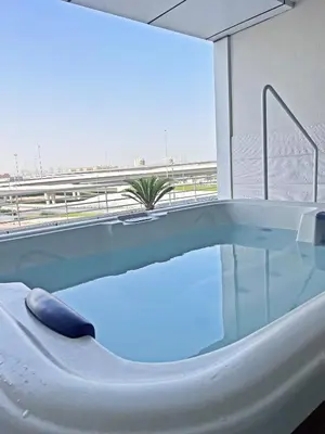 a bath tub with a view of the beach at Stunning Panoramic Sea & Marina City Skyline View in Dubai