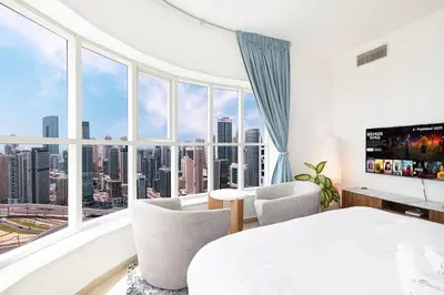 a bedroom with a bed and a large window at Stunning Panoramic Sea & Marina City Skyline View in Dubai