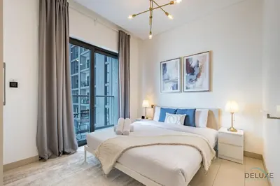 a bedroom with a large bed and a large window at Charming 1BR Apartment in Sobha Creek Vistas Reserve, Al Merkadh by Deluxe Holiday Homes in Dubai