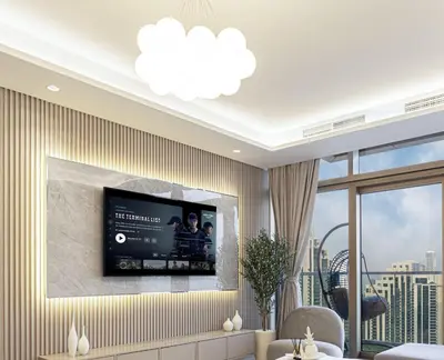 a living room with a flat screen tv on a wall at 64th Floor Highest Downtown Infinity Pool Burj Khalifa View in Dubai