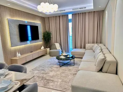 a living room with a couch and a flat screen tv at 64th Floor Highest Downtown Infinity Pool Burj Khalifa View in Dubai