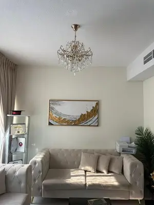 a living room with a couch and a chandelier at Villa Townhouse in Dubai