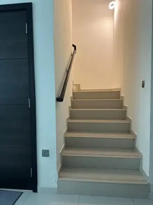 a stairway with a black door and a stair case at Villa Townhouse in Dubai