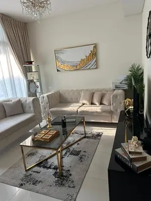 a living room with a couch and a coffee table at Villa Townhouse in Dubai
