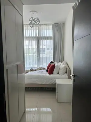 a bedroom with a bed with pillows and a window at Villa Townhouse in Dubai