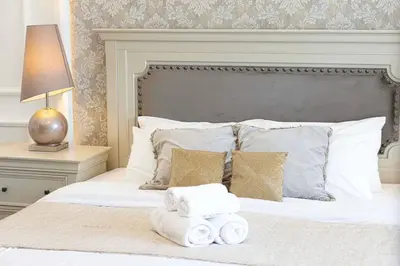 a bedroom with a bed with towels on it at Classic Charm a Studio with Iconic Marina Views in Dubai