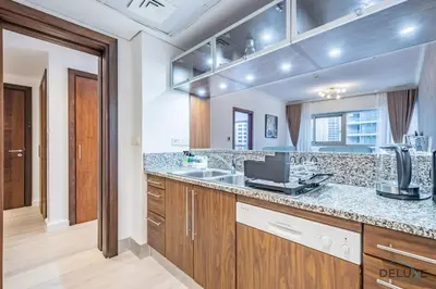 a kitchen with a counter top and a sink at Stylish 1BR Apartment in Al Sahab 2, Dubai Marina by Deluxe Holiday Homes in Dubai