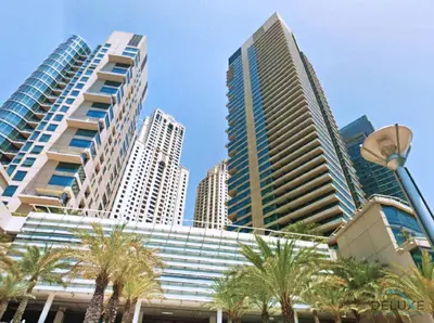 a group of tall buildings in a city with palm trees at Stylish 1BR Apartment in Al Sahab 2, Dubai Marina by Deluxe Holiday Homes in Dubai