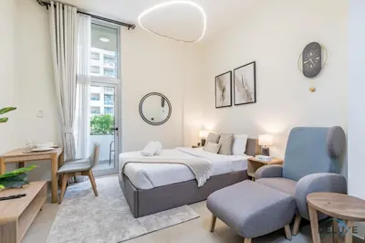 a hotel room with a bed and a chair at Stunning Studio Apartment in Azizi Star , Jebel Ali by Deluxe Holiday Homes in Dubai