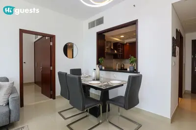 a dining room with a table and black chairs at HiGuests - Exclusive Downtown Dubai 1BR Apt at 29 Boulevard in Dubai
