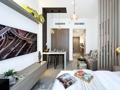 a bedroom with a large painting on the wall at Trophy Modern Marvel Cozy Studio with Smart Features in Azizi Riviera in Dubai