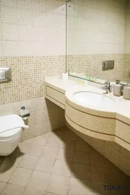 a bathroom with a toilet and a sink and a mirror at 3-BHK - Dubai Marina - 44th Floor - 5mins to beach in Dubai