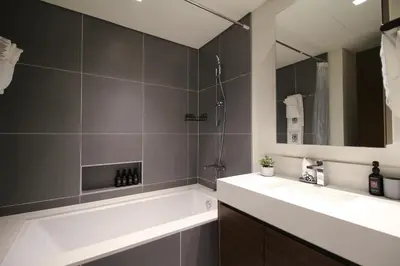 a bathroom with a tub and a sink and a mirror at Trophy - Ultra Luxury Suite with Fireplace in Dubai