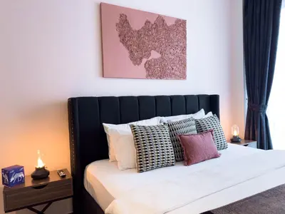 a bedroom with a black and white bed with pillows at Naseem - Stylish 1BR Hotel Apartment Overlooking the Marina in Dubai