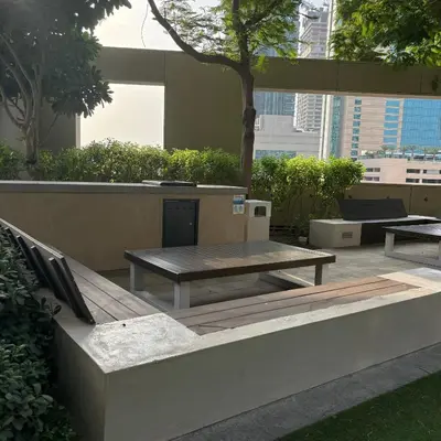 a patio with a wooden table and a bench at Stunning Burj Khalifa & Fountain view - Dubai Mall Access, Burj vista Downtown Dubai in Dubai