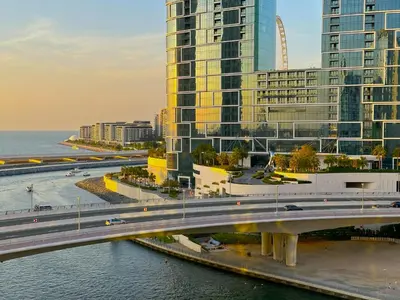 a bridge over a river in front of tall buildings at Luxury RoofTop Pool with Full Marina View 45 percent OFF in Dubai