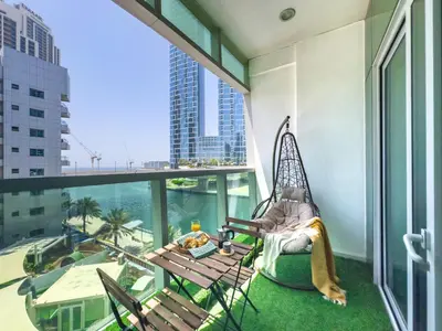 a person sitting in a hammock on a balcony at Luxury RoofTop Pool with Full Marina View 45 percent OFF in Dubai