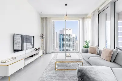 a living room with a couch and a tv at Stylish 2BR in Forte 2 in Dubai