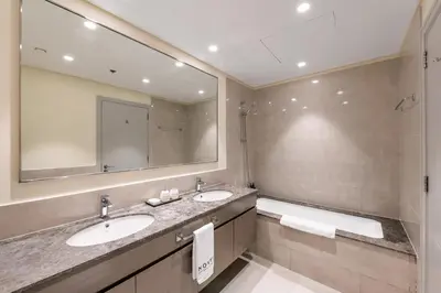 a bathroom with two sinks and a large mirror at Stylish 2BR in Forte 2 in Dubai