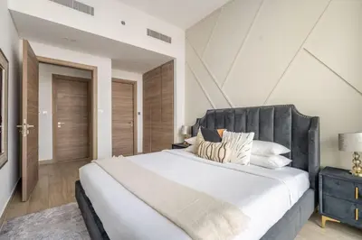 a bedroom with a large bed with a gray headboard at GuestReady - Lux nest near JBR beach in Dubai