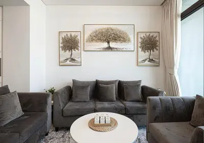 a living room with a couch and a table at Palace Residences 2BR with Stunning Creek Views in Dubai